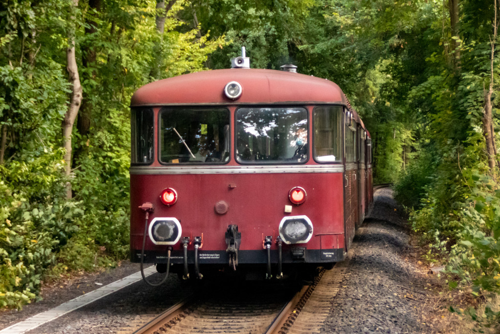 996 677, 798 589, 996 310 und 798 829 verschwinden im Wald bei Köppern auf der Taunusbahn, aufgenommen am 11.09.2022.