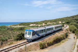 Ein Soulé-Triebwagen inkl. Steuerwagen zwischen Strand und Campingplatz bei Botri, aufgenommen am 13.08.2024 auf Korsika.
